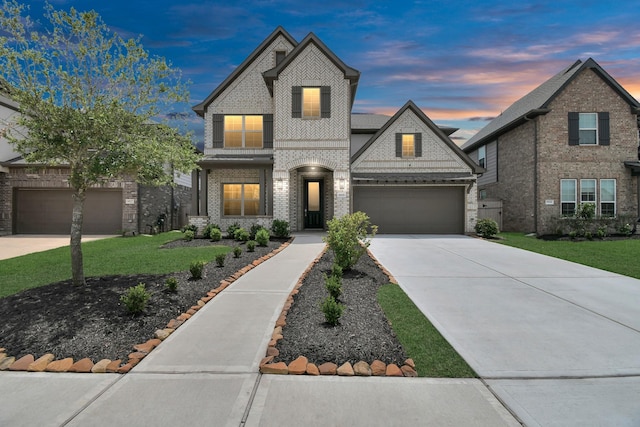 view of front of home featuring a yard and a garage