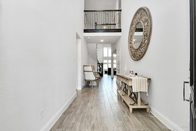 foyer entrance with hardwood / wood-style floors and a high ceiling