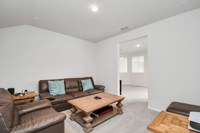 carpeted living room with vaulted ceiling