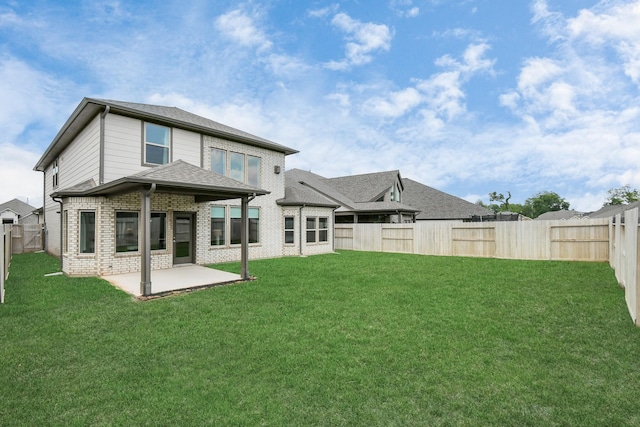 back of property with a lawn and a patio area