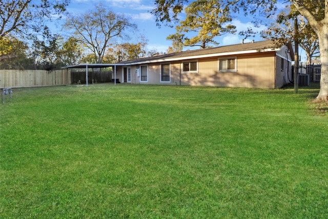 back of property with a lawn, a sunroom, and central air condition unit