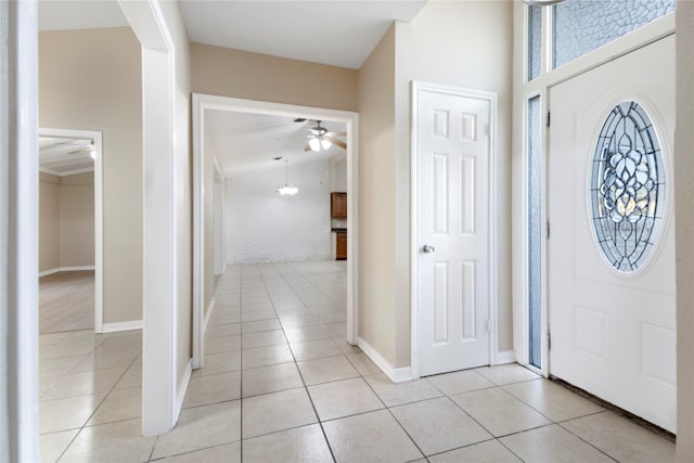 entryway with ceiling fan and light tile patterned flooring