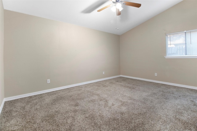 carpeted spare room featuring ceiling fan and vaulted ceiling