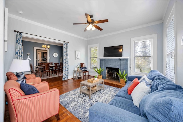 living room with a fireplace, ornamental molding, dark hardwood / wood-style flooring, and a healthy amount of sunlight