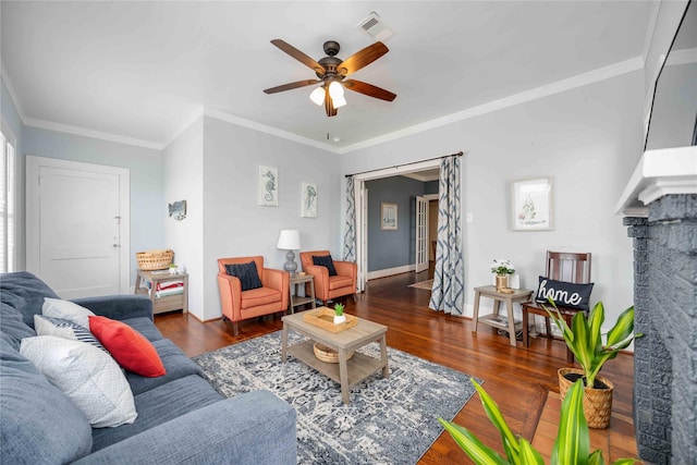 living room featuring ornamental molding, ceiling fan, and dark wood-type flooring