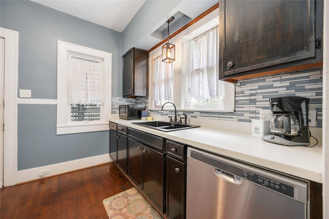 kitchen with pendant lighting, dishwasher, backsplash, sink, and dark hardwood / wood-style floors