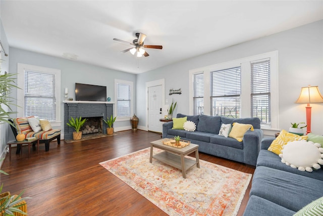 living room featuring a fireplace, dark hardwood / wood-style flooring, and ceiling fan