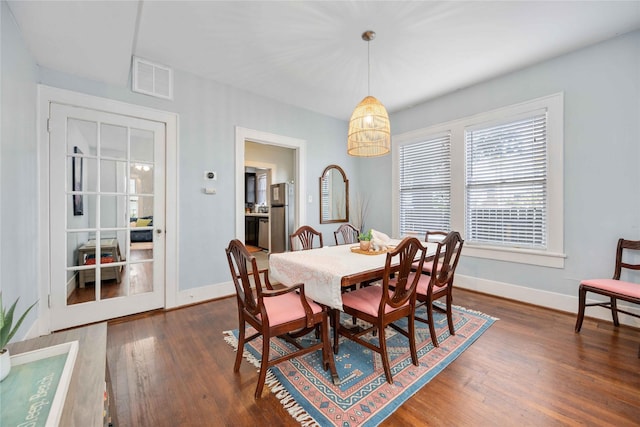 dining space with dark hardwood / wood-style floors