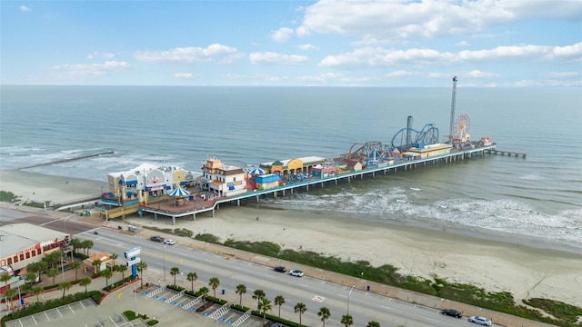 birds eye view of property featuring a water view and a beach view