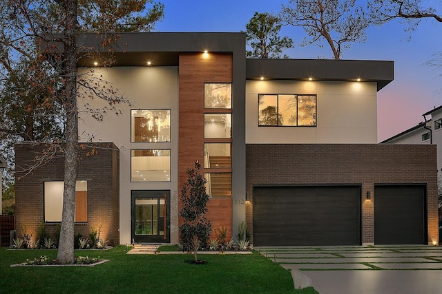 contemporary house with a lawn and a garage