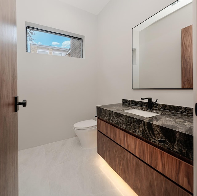 bathroom with vanity and toilet