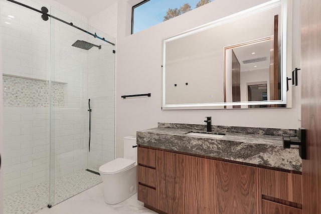 bathroom featuring vanity, an enclosed shower, and toilet