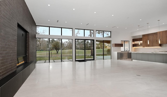 unfurnished living room with a towering ceiling