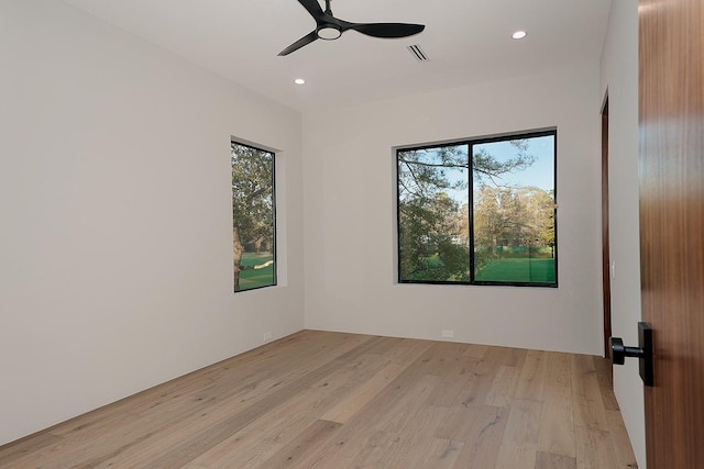 empty room featuring ceiling fan and light hardwood / wood-style flooring