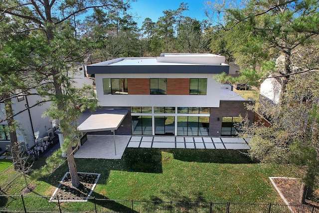 rear view of house with a yard and a patio