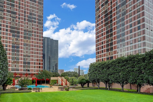 view of community featuring a patio area and a yard