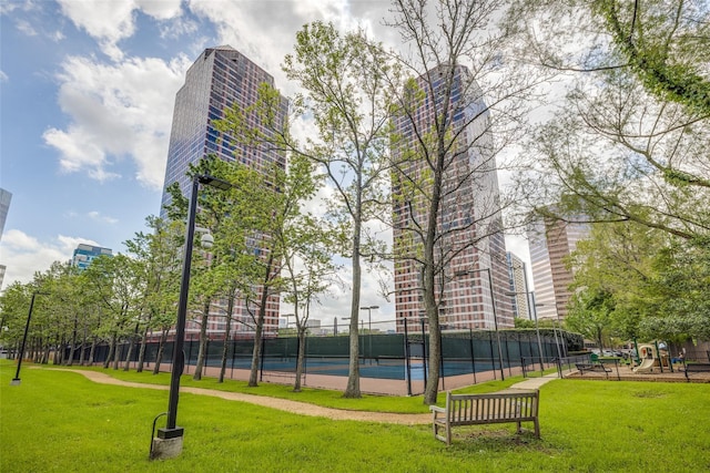 view of property's community with a playground and a yard