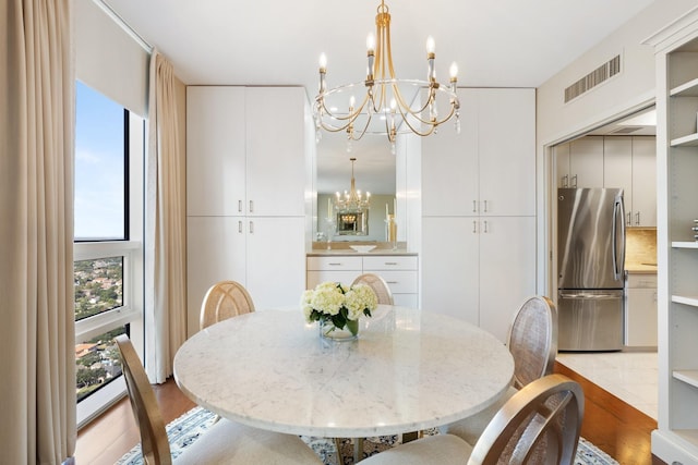 dining room featuring light hardwood / wood-style floors and an inviting chandelier