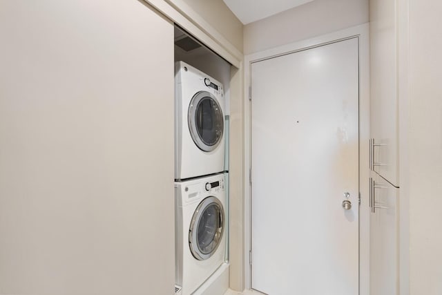 laundry area featuring stacked washer / drying machine