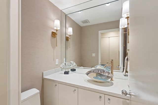 bathroom featuring vanity and toilet