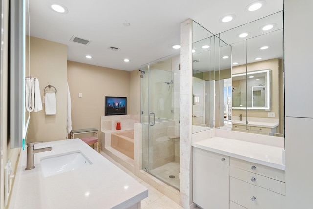 bathroom with tile patterned flooring, shower with separate bathtub, and vanity