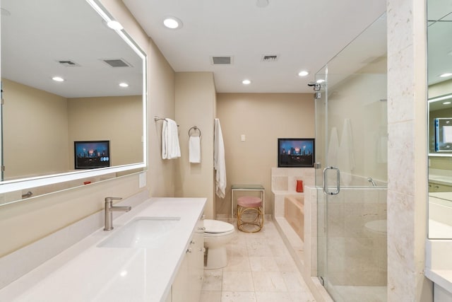 full bathroom with plus walk in shower, tile patterned floors, vanity, and toilet