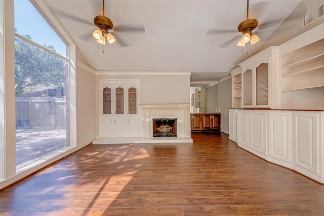 unfurnished living room featuring dark wood-type flooring, crown molding, ceiling fan, and lofted ceiling