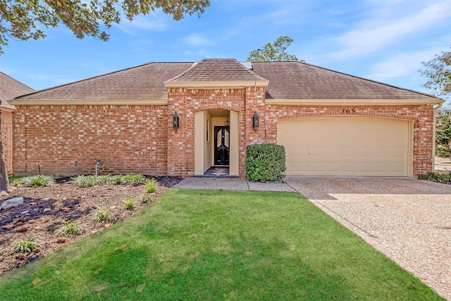 view of front facade with a garage and a front lawn