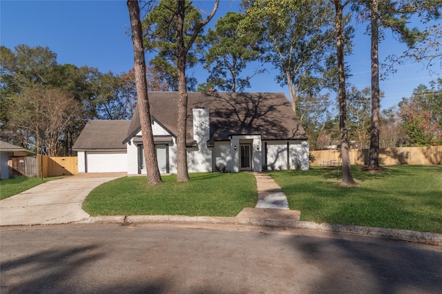 view of front of home featuring a front yard and a garage