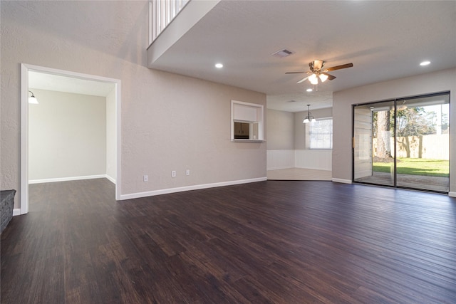 unfurnished living room with dark hardwood / wood-style floors and ceiling fan with notable chandelier