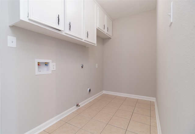 laundry area featuring hookup for an electric dryer, washer hookup, cabinets, gas dryer hookup, and light tile patterned flooring