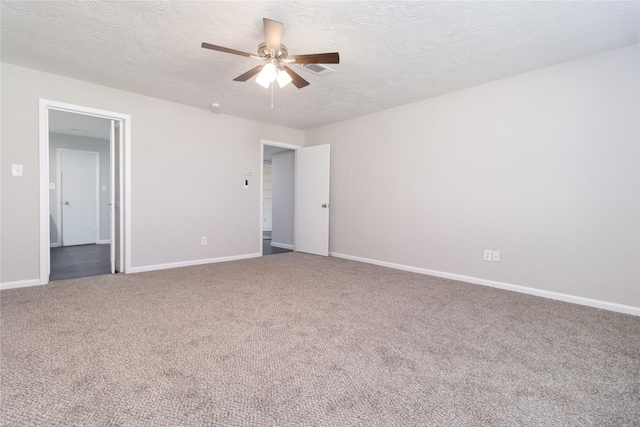 spare room featuring carpet, ceiling fan, and a textured ceiling