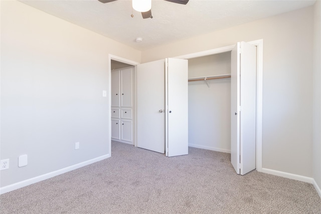 unfurnished bedroom with ceiling fan, a closet, and light colored carpet