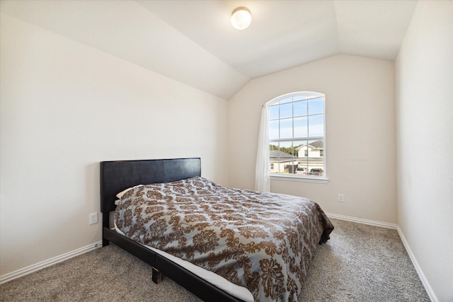 carpeted bedroom featuring vaulted ceiling