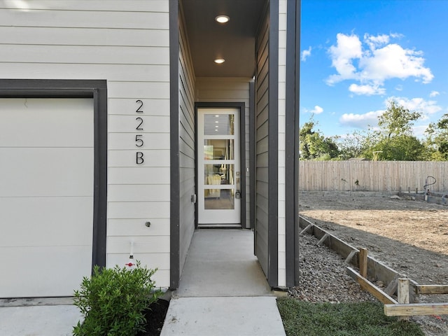 view of exterior entry featuring a garage