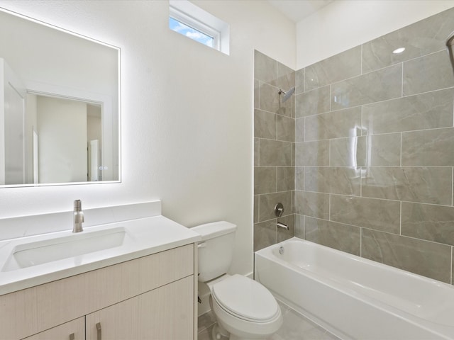 full bathroom featuring toilet, tiled shower / bath, and vanity