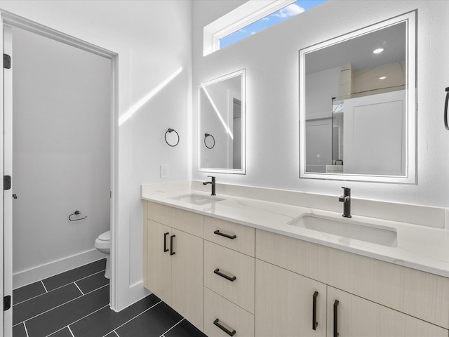 bathroom featuring tile patterned floors, toilet, and vanity