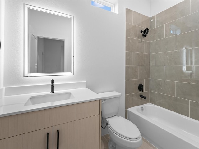 full bathroom featuring toilet, tiled shower / bath combo, and vanity