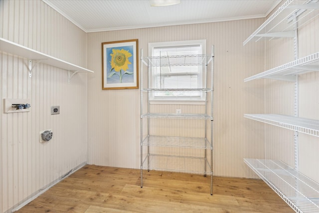 laundry room with crown molding, wood-type flooring, and electric dryer hookup