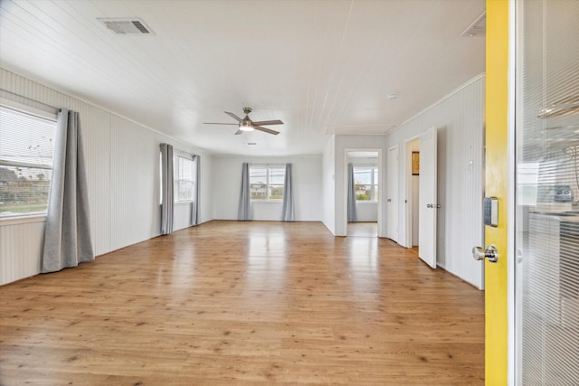 unfurnished room featuring ceiling fan, light wood-type flooring, and crown molding