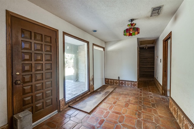 entrance foyer featuring a textured ceiling