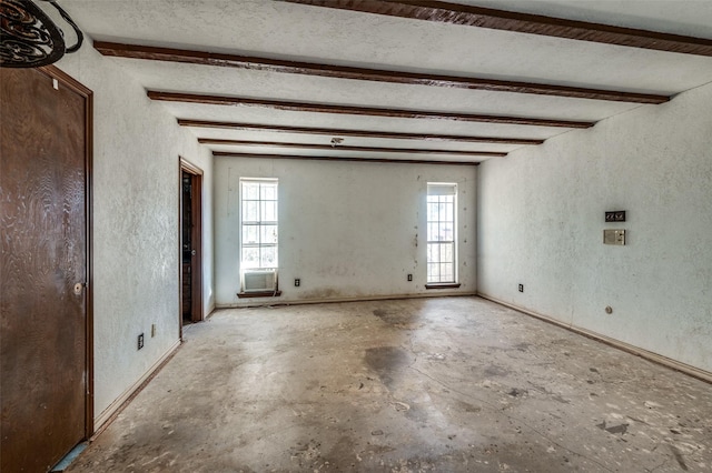 unfurnished room featuring beam ceiling, a wealth of natural light, and cooling unit