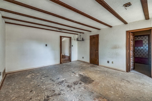 spare room with beam ceiling