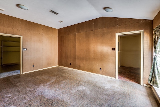 spare room with hardwood / wood-style floors and lofted ceiling