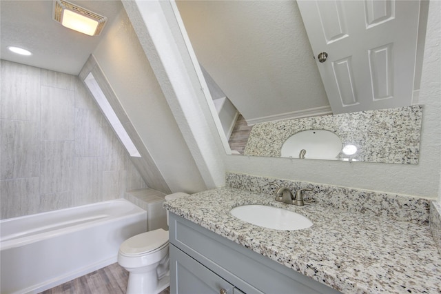 full bathroom featuring hardwood / wood-style flooring, vanity, toilet, and tiled shower / bath