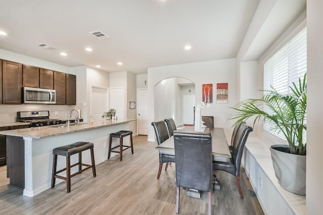 dining room featuring light wood-type flooring and sink