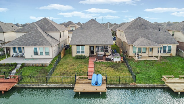 rear view of property featuring a patio area and a water view