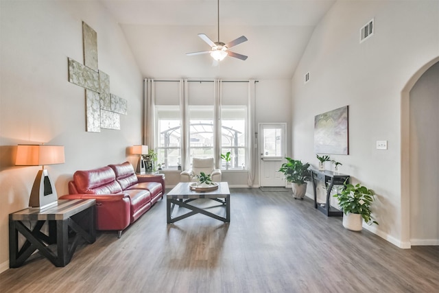 living room with ceiling fan, wood-type flooring, and high vaulted ceiling