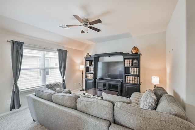 living room featuring carpet floors, ceiling fan, and lofted ceiling