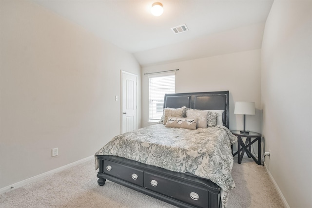 bedroom featuring light carpet and vaulted ceiling